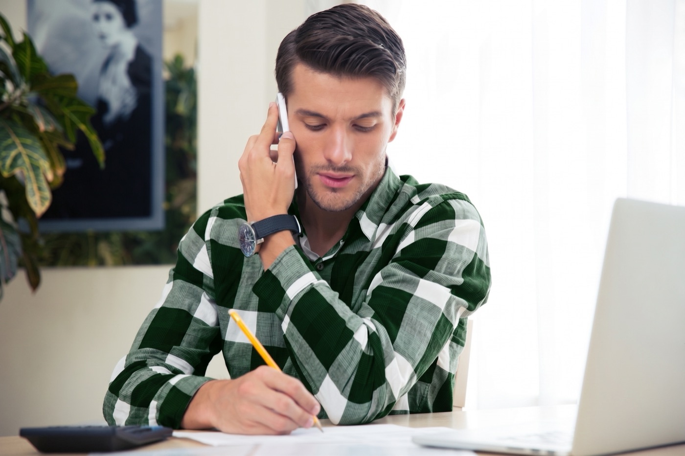 A bookkeeper on the phone at a desk